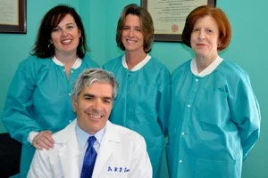 Dr. Eaves seated with three team members
